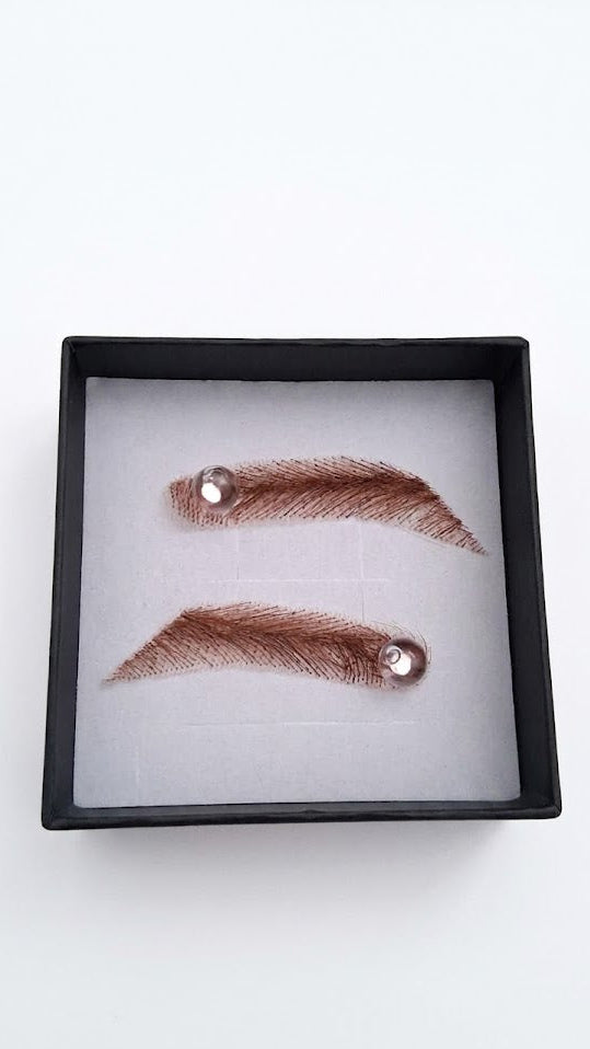 Pair of false eyelashes in a black display case on a white background
