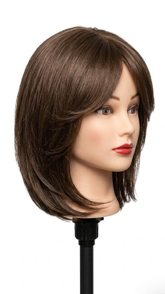 Mannequin head with brown hair on a white background