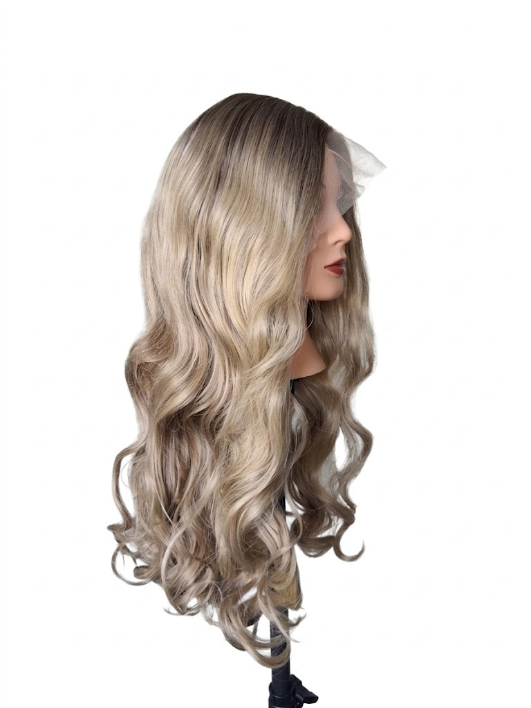 Mannequin head with long, wavy, blonde wig on a white background