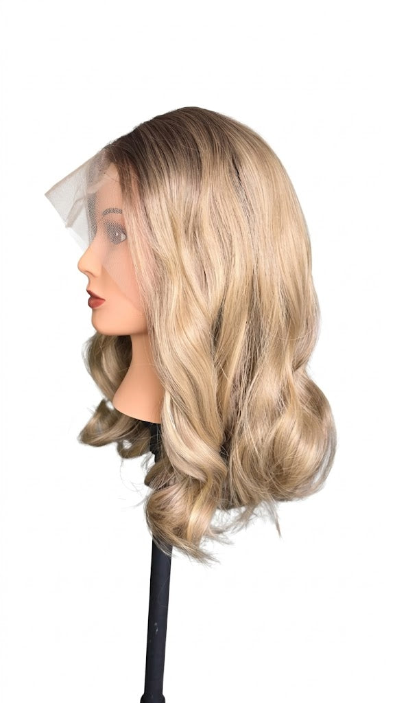 Blonde wig on a mannequin head with a white background