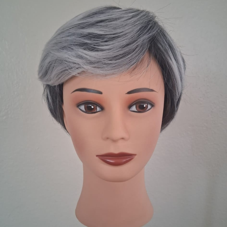 Mannequin head with gray hair on a plain background