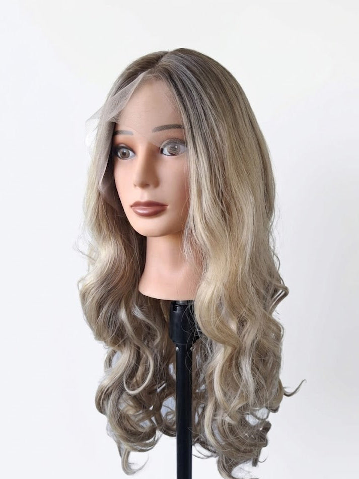 Mannequin head with wavy gray hair on a white background