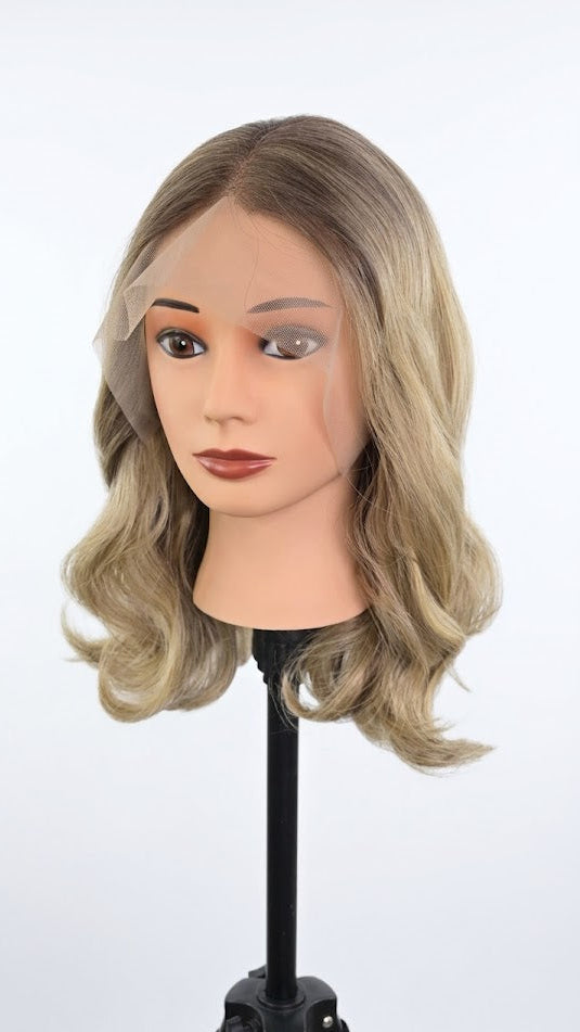 Mannequin head with wavy blonde hair on a white background