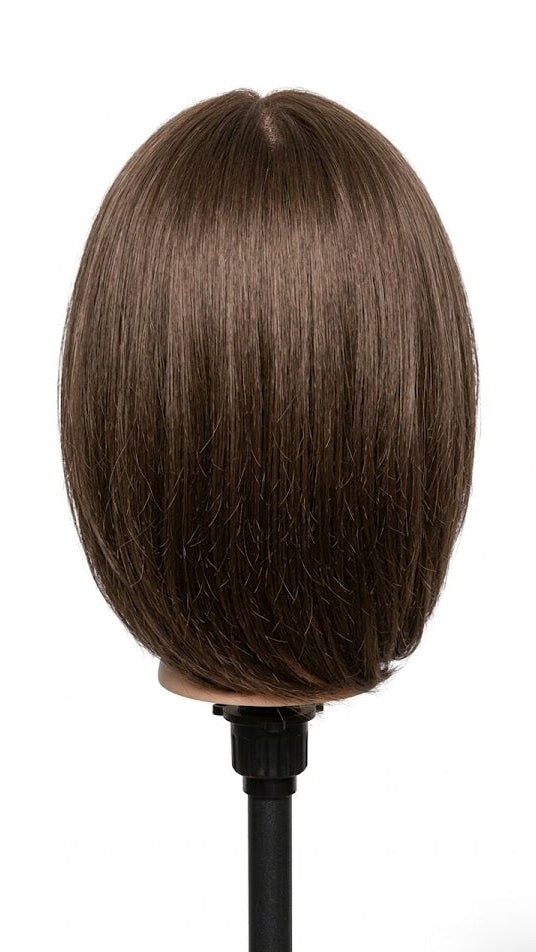 Brown hairpiece on a mannequin head against a white background