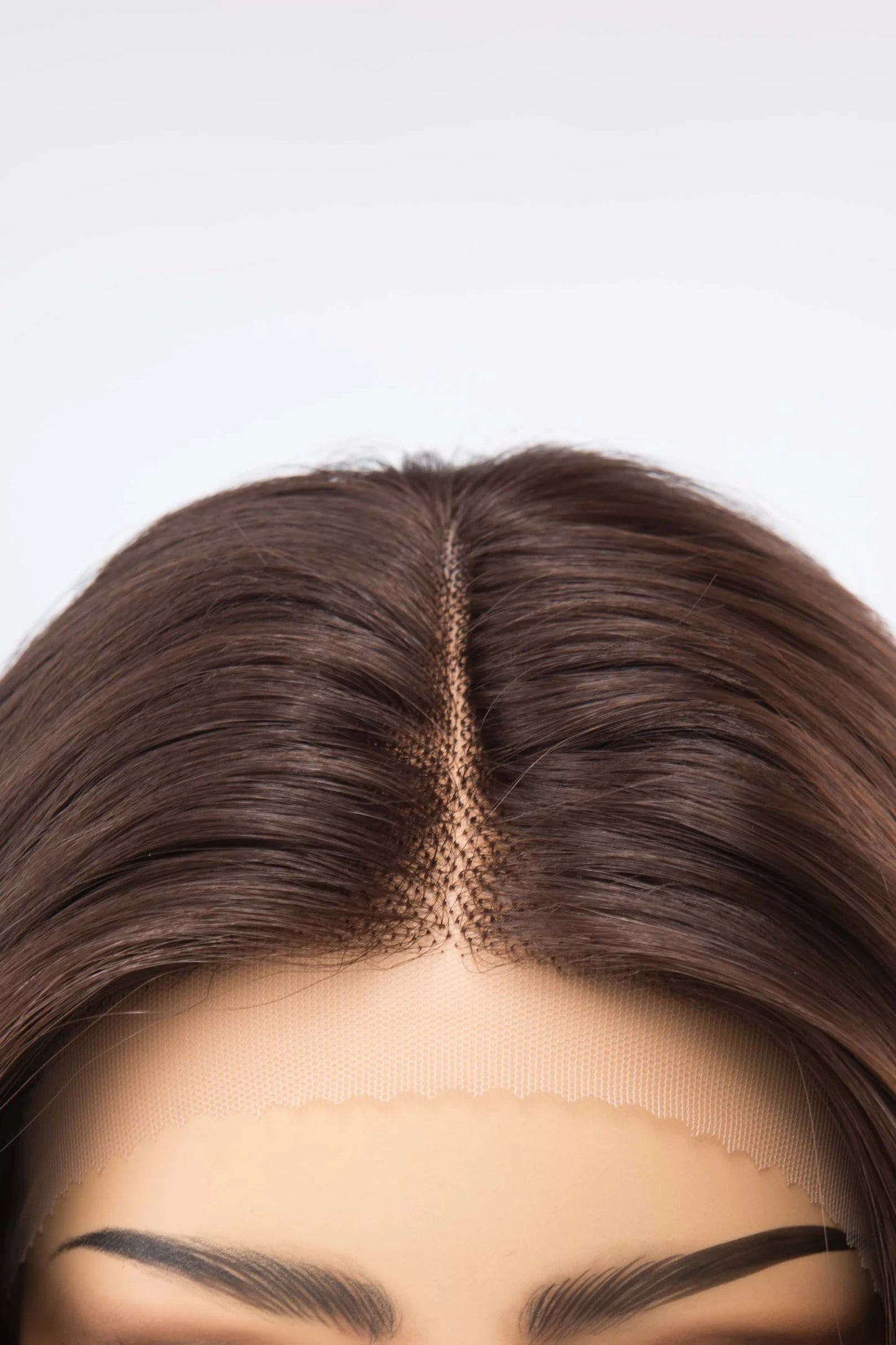 Close-up of a wig with a plain background