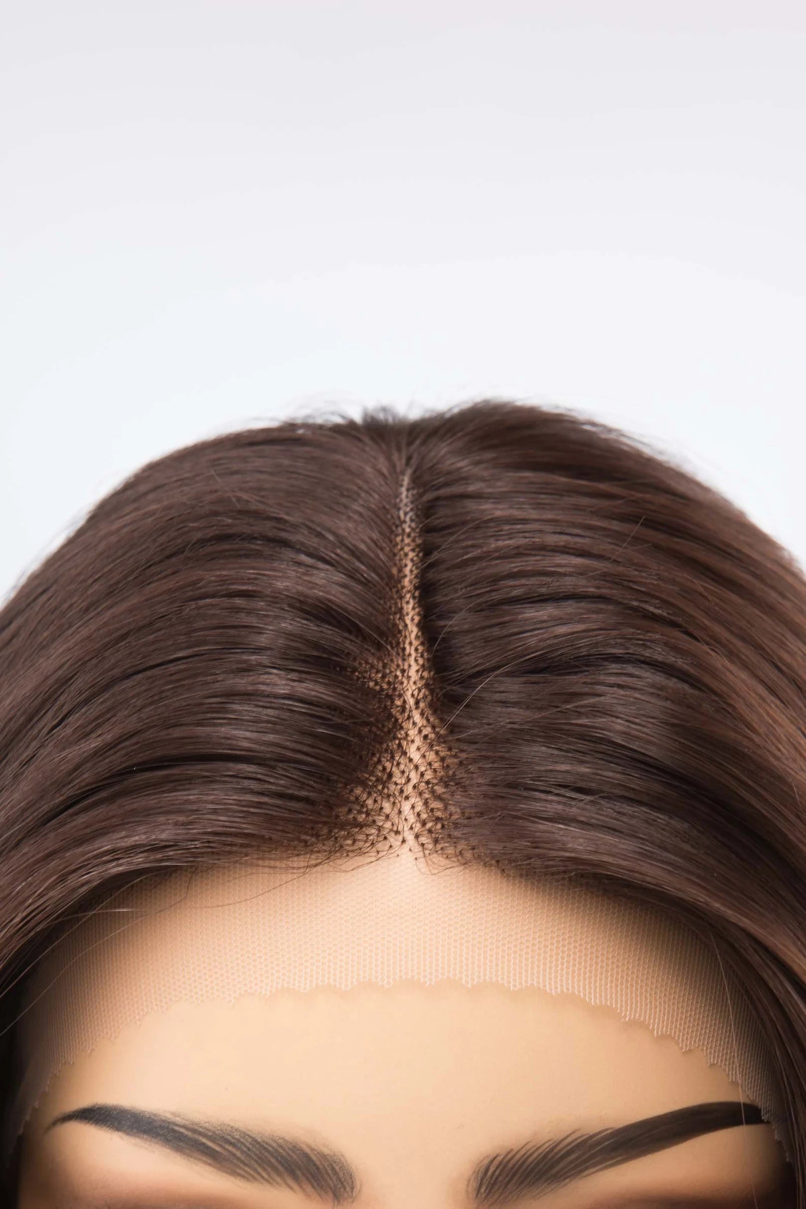 Close-up of a wig with a plain background