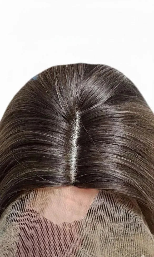Close-up of a person with long, straight hair on a white background