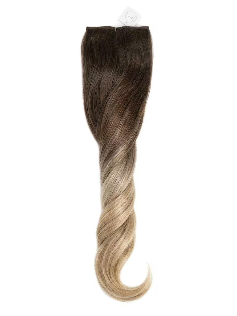 Hair extension with brown to blonde gradient on a white background