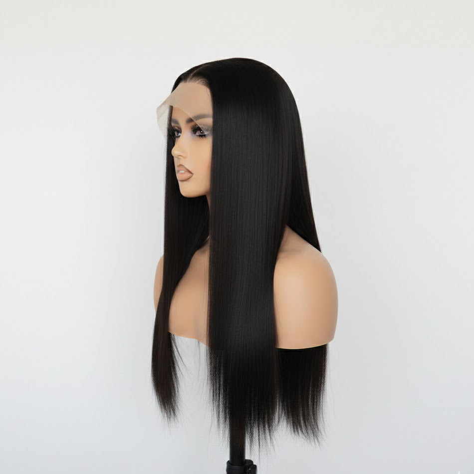 Black wig on a mannequin head against a white background