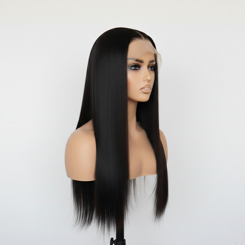 Black straight wig on a mannequin head against a white background