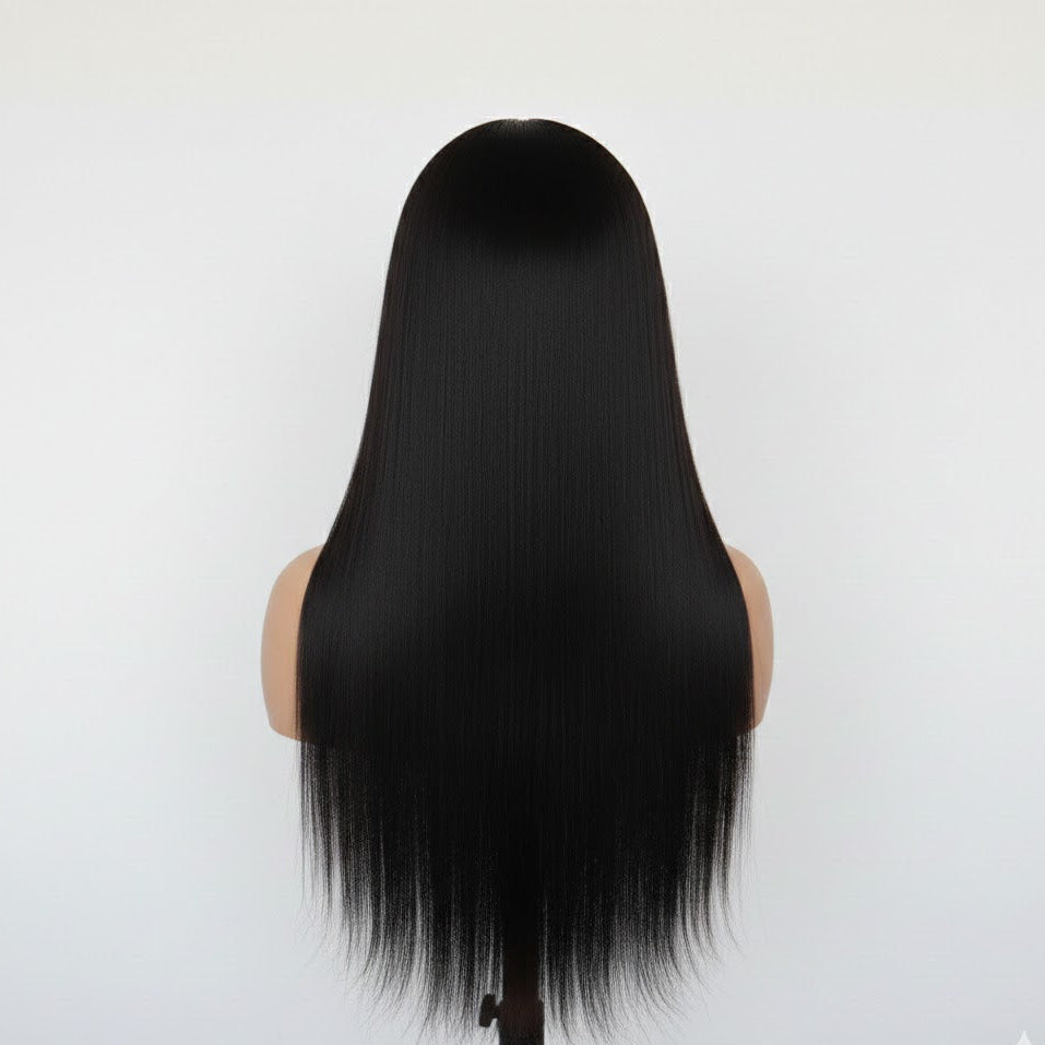 Black wig on a mannequin head against a white background