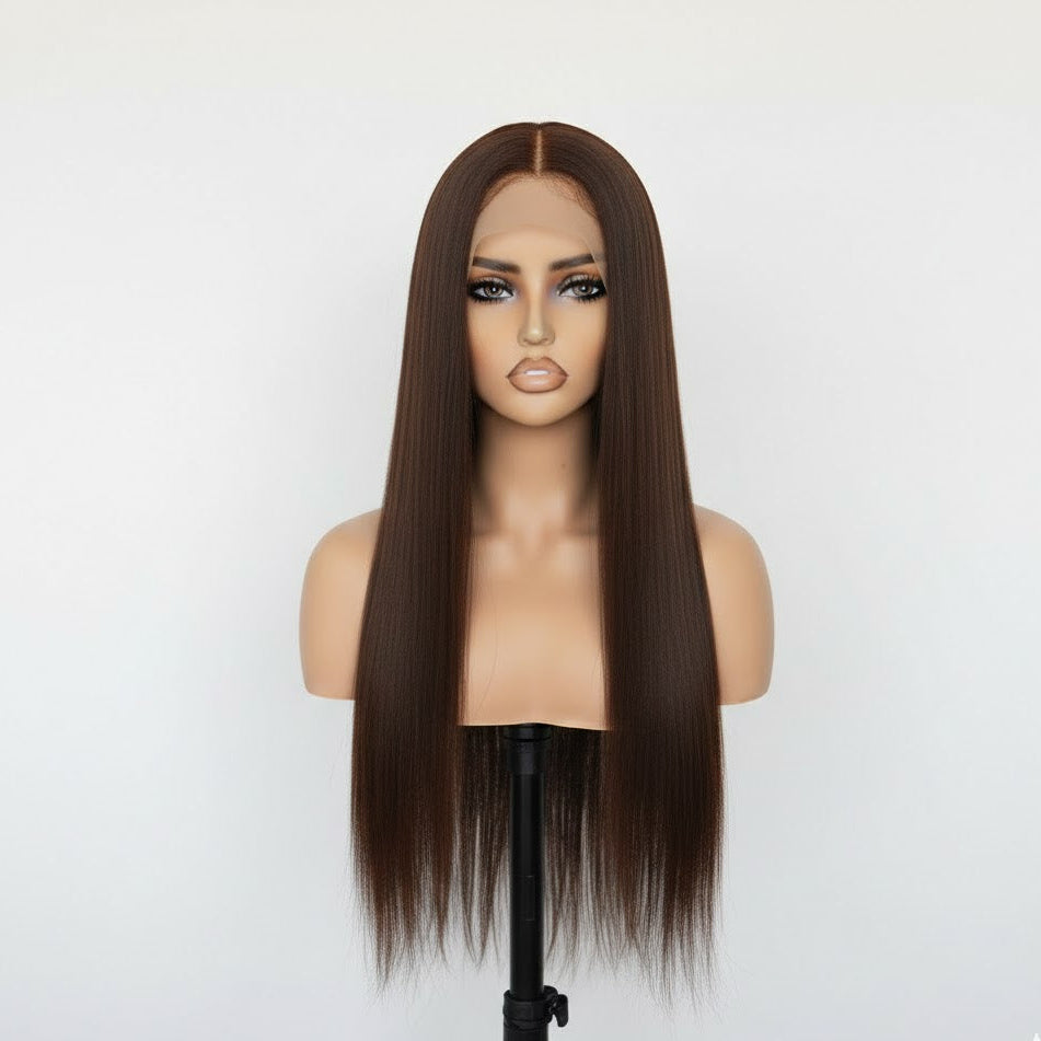 Brown wig on a mannequin head against a white background