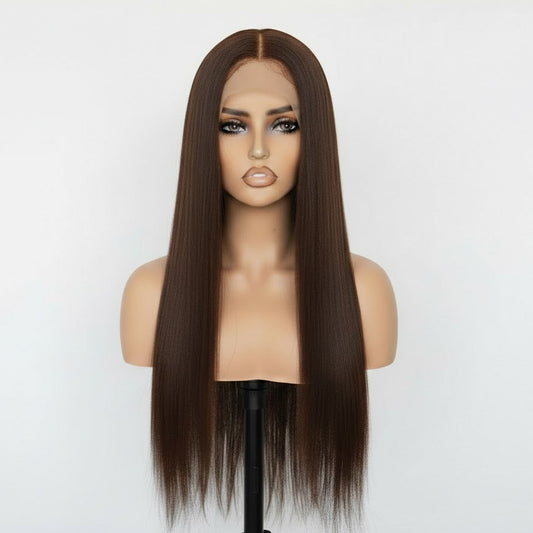 Brown wig on a mannequin head against a white background