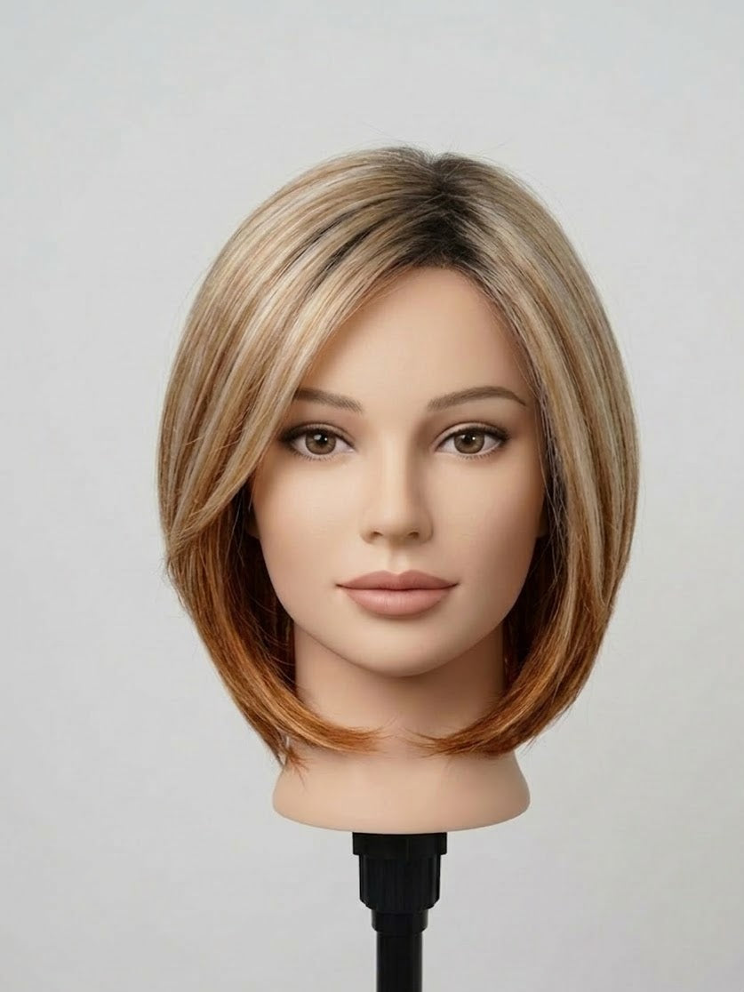 Mannequin head with a styled haircut on a gray background