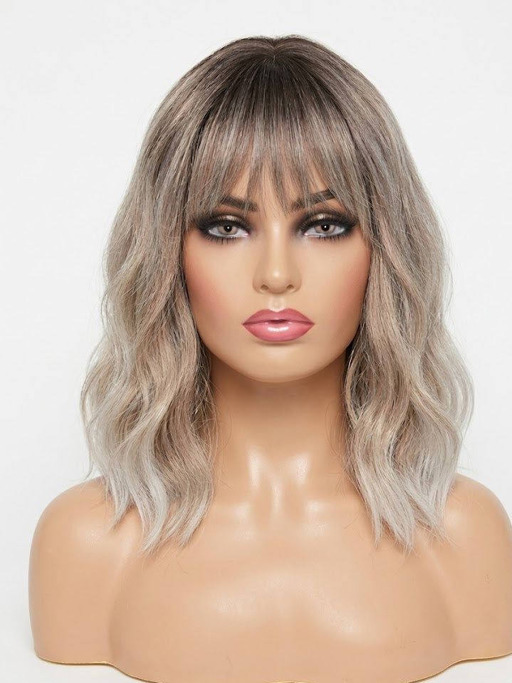 Mannequin head with a gray wavy wig on a white background