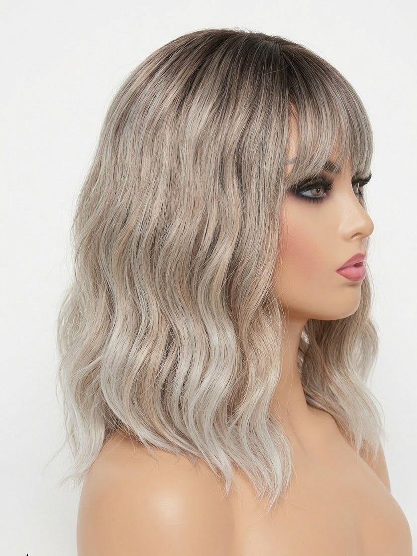 Woman wearing a gray wig with wavy hair on a white background